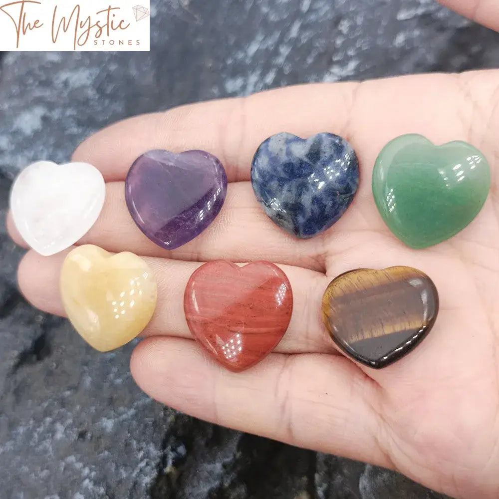 A set of seven heart-shaped stones representing the seven chakras is displayed.