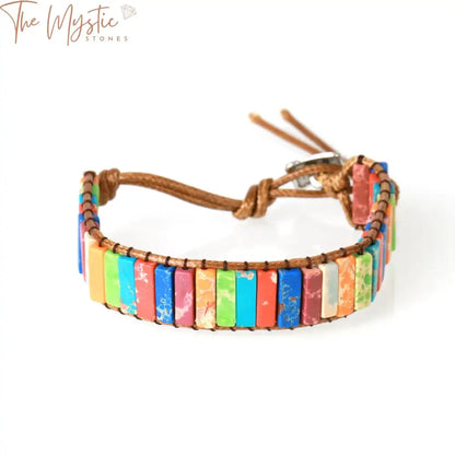 A handmade 7 chakra bracelet with colorful jasper stones, featuring a leather wrap design.