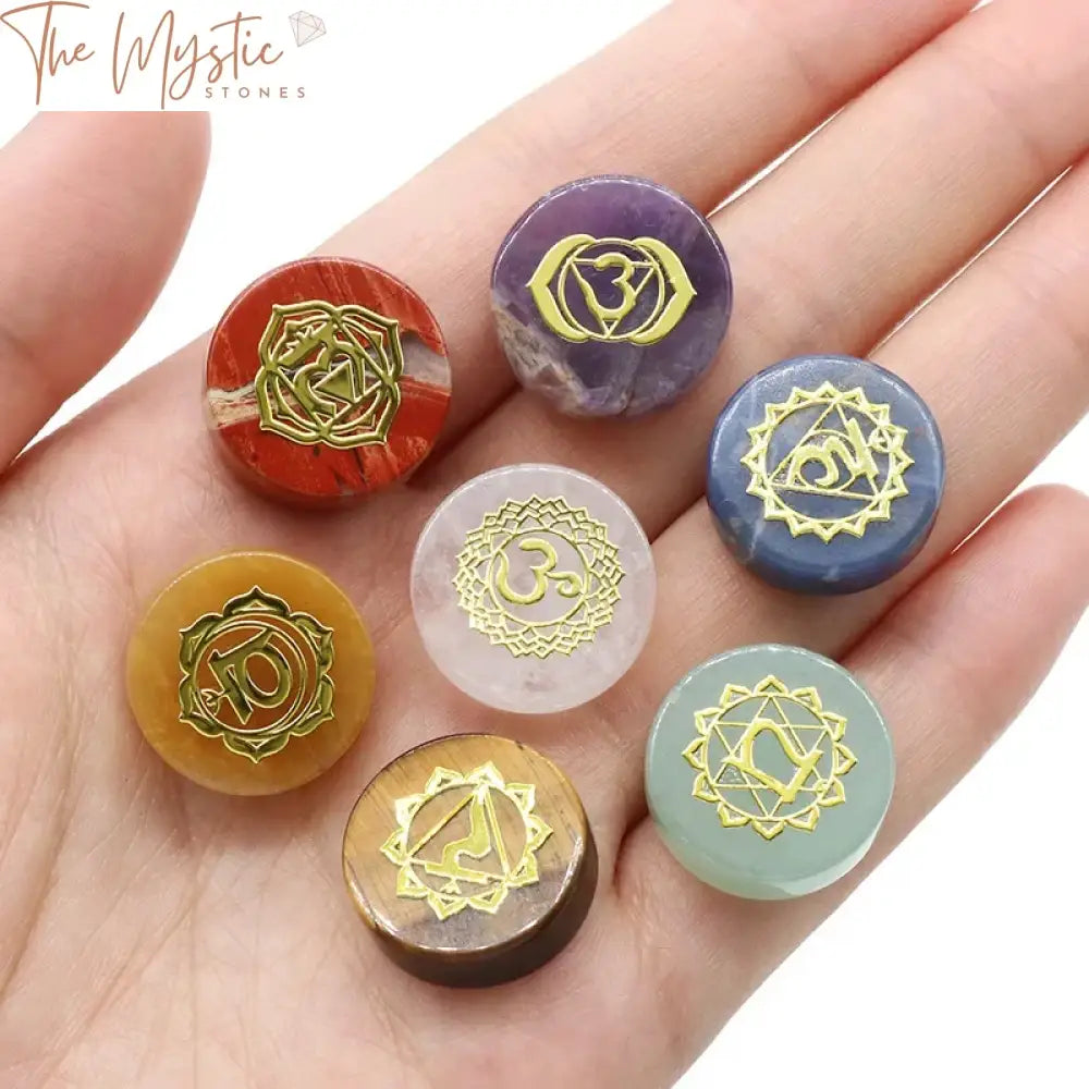 A collection of polished pocket-sized stones, each representing the seven chakras, arranged in a visually appealing layout.