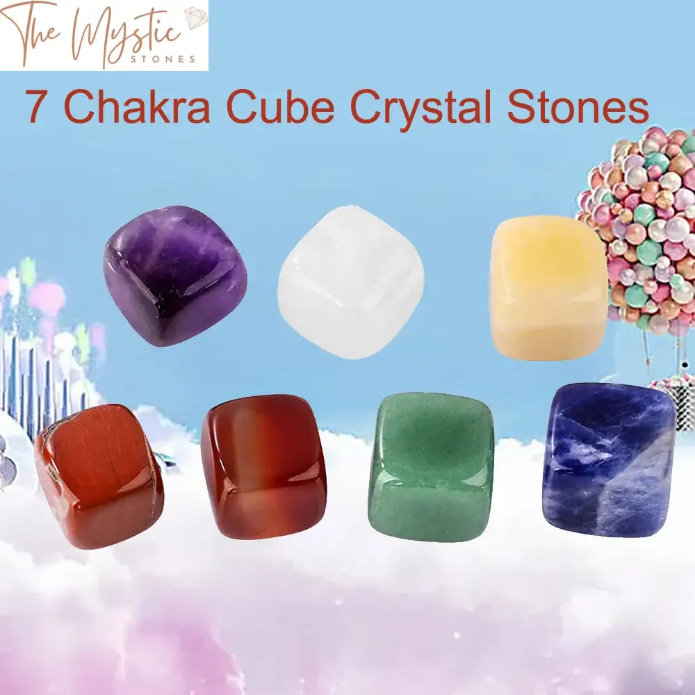 A set of seven polished, cube-shaped gemstones, each representing a different chakra.