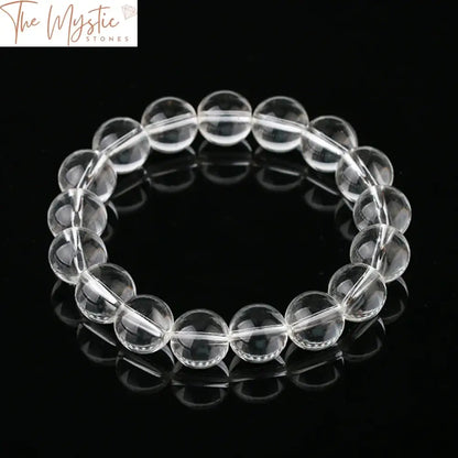 A bracelet made of 12mm natural gemstone beads featuring white clear quartz rock crystals.