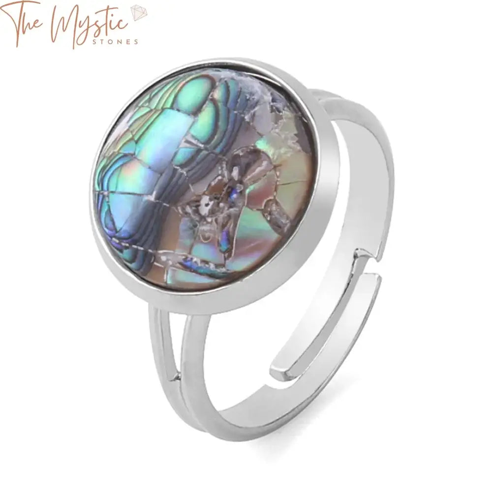 A round natural seashell ring with a pink and white colorful abalone shell design.