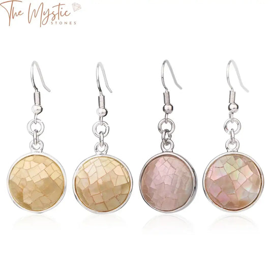 A pair of round natural seashell drop earrings featuring abalone shell with a simple design.