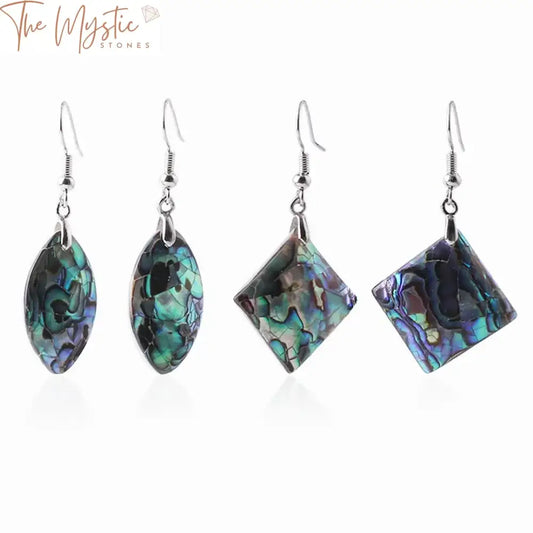 A pair of geometric dangle earrings featuring natural abalone shell designs.