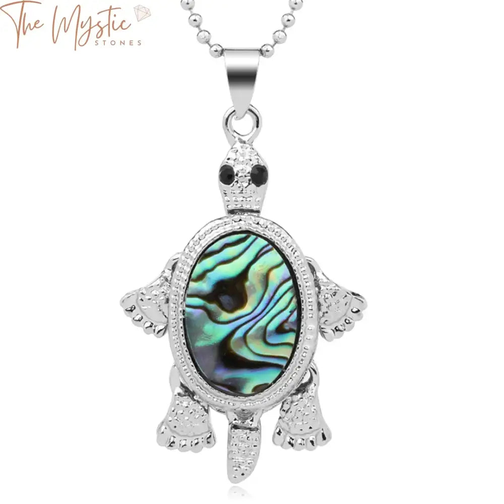 A close-up image of a vibrant necklace featuring a tortoise-shaped pendant crafted from a natural abalone shell.