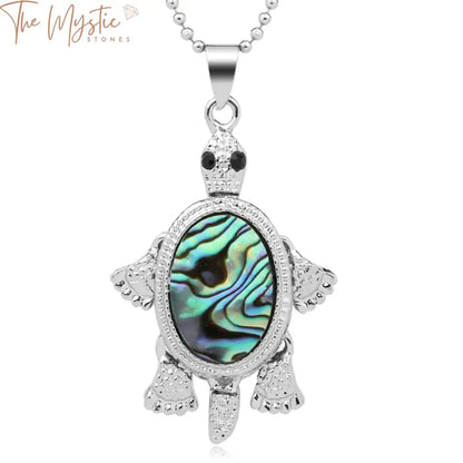 A close-up image of a vibrant necklace featuring a tortoise-shaped pendant crafted from a natural abalone shell.