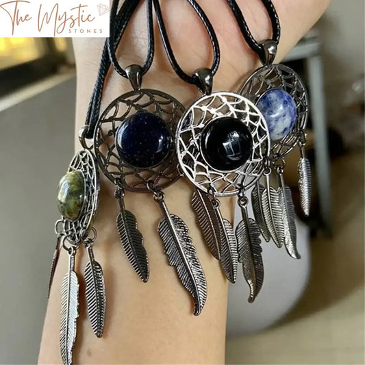 A natural agate crystal dream catcher pendant featuring a large central agate stone surrounded by a delicate web design.