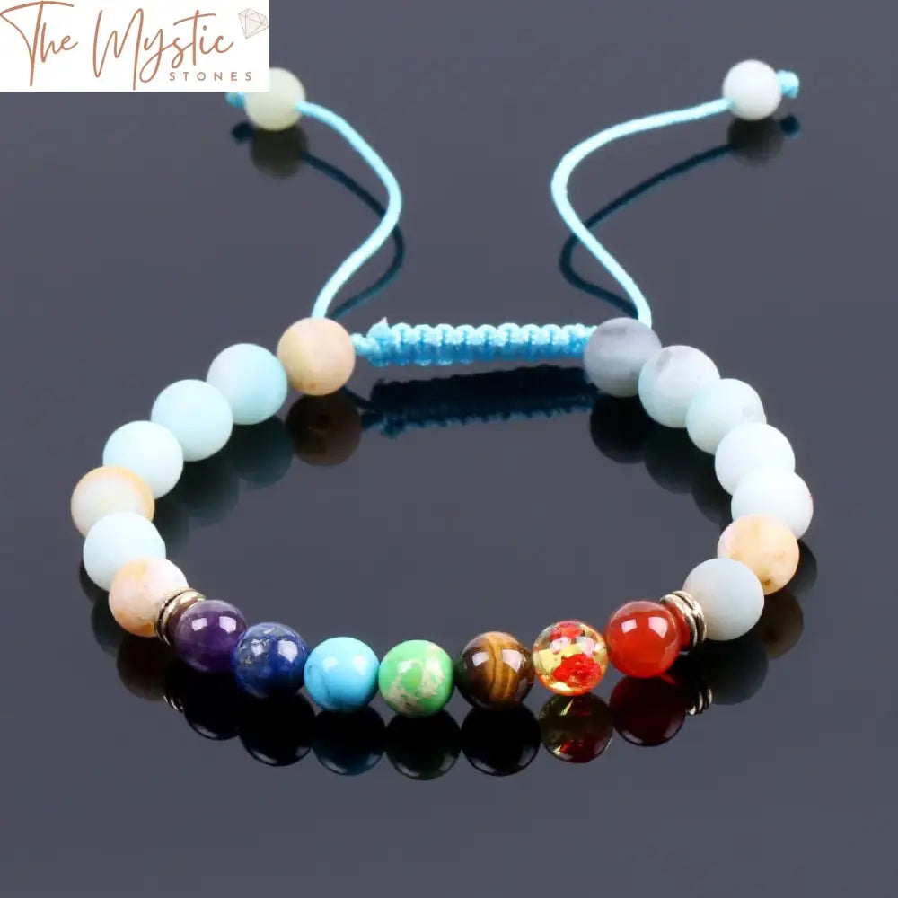 A braided bracelet featuring natural Amazonite blue stones, accented by round beads representing the seven chakras.