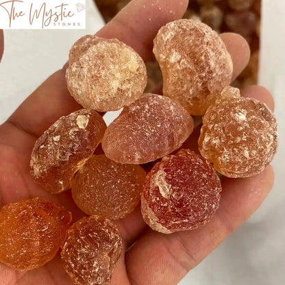 A collection of raw amber stones in varying sizes and shades of golden-yellow, displaying their natural rough textures.