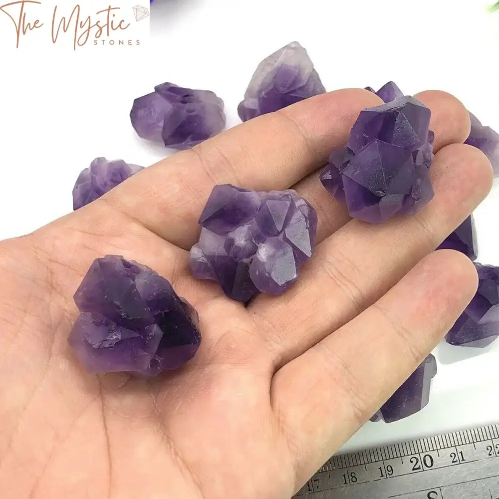 A collection of natural amethyst flower points, showcasing rough, vibrant purple crystals with unique formations.