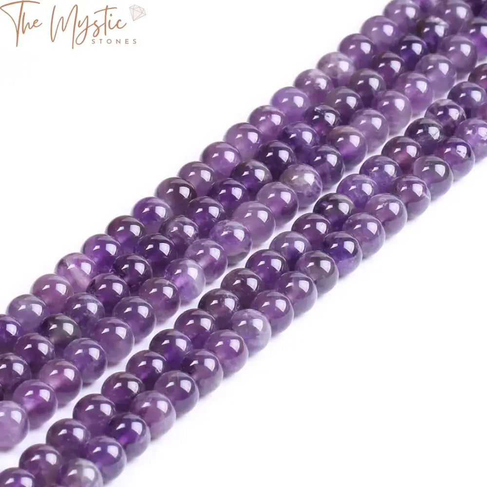 A collection of smooth, round 8mm purple quartz beads, known as amethysts, displayed on a white background.