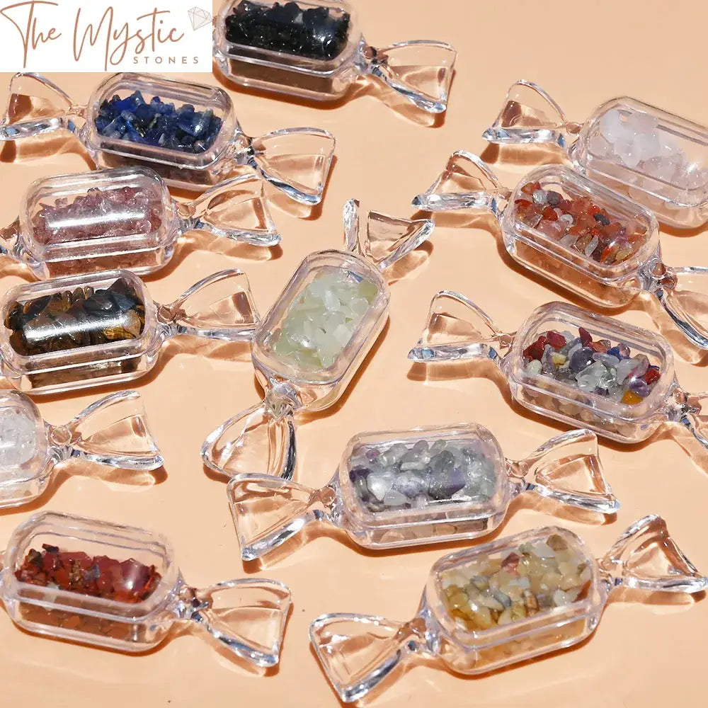 A collection of small, polished crystal chip stones in various shades of purple and white, resembling candy shapes.