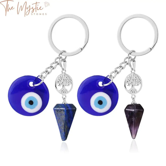 A display of Evil Eye keychains featuring natural crystal stones, including Amethysts and Quartz, arranged neatly.