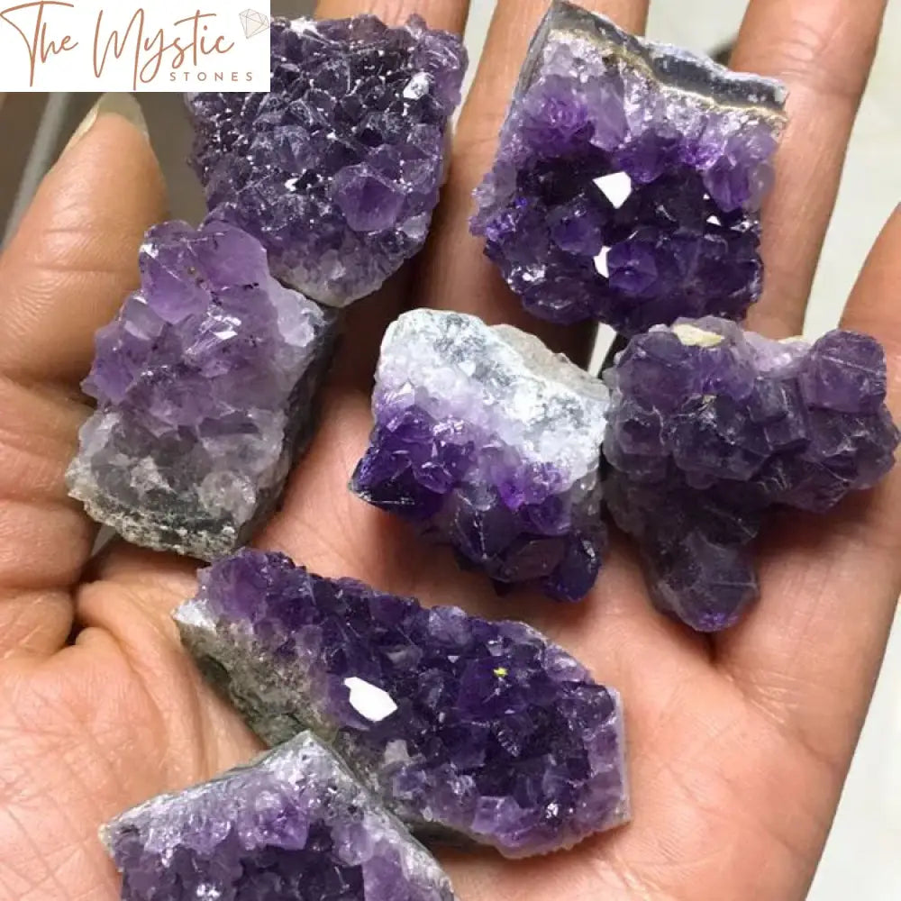 A cluster of natural raw amethyst quartz geode, showcasing vibrant purple crystals with a druzy texture.