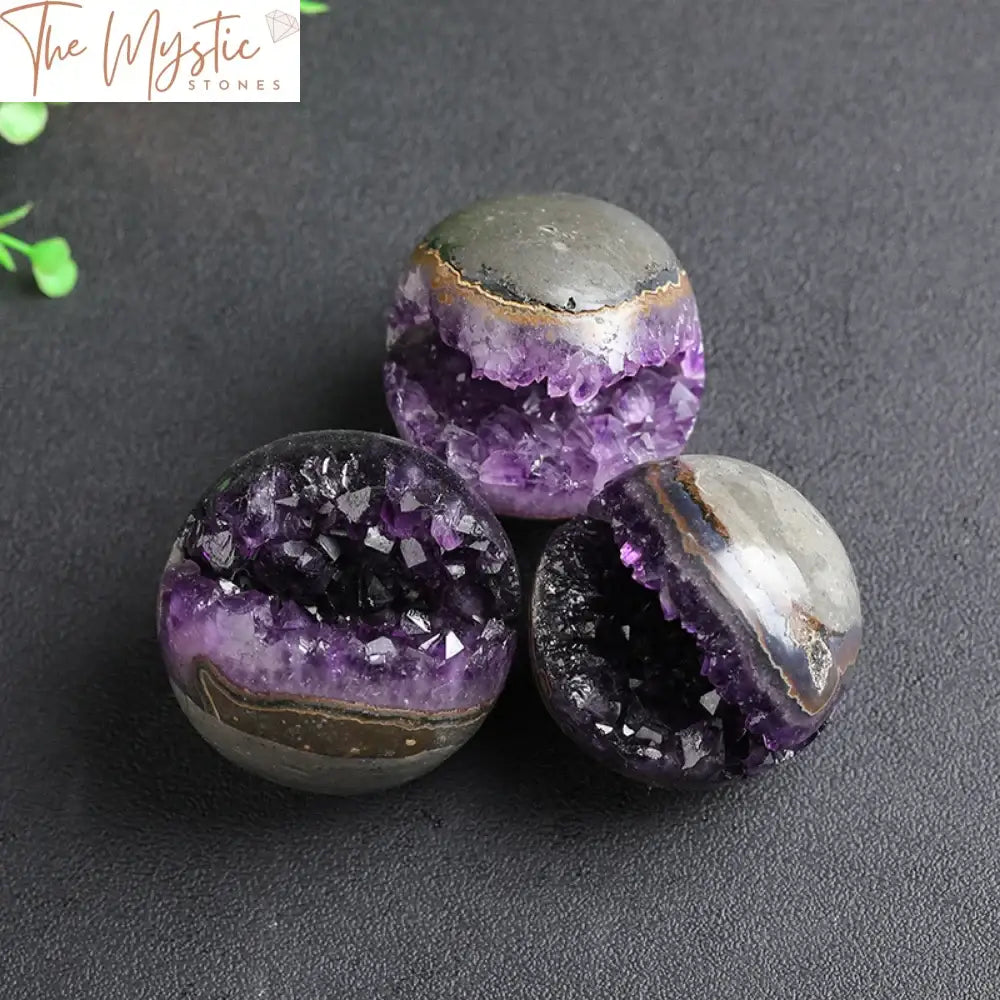 A natural amethyst geode quartz cluster crystal ball displayed in a well-lit room.