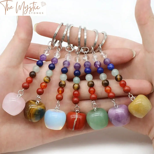 A 20mm Mini Apple-shaped reiki crystal keychain showcasing vibrant 7 chakra gemstones.