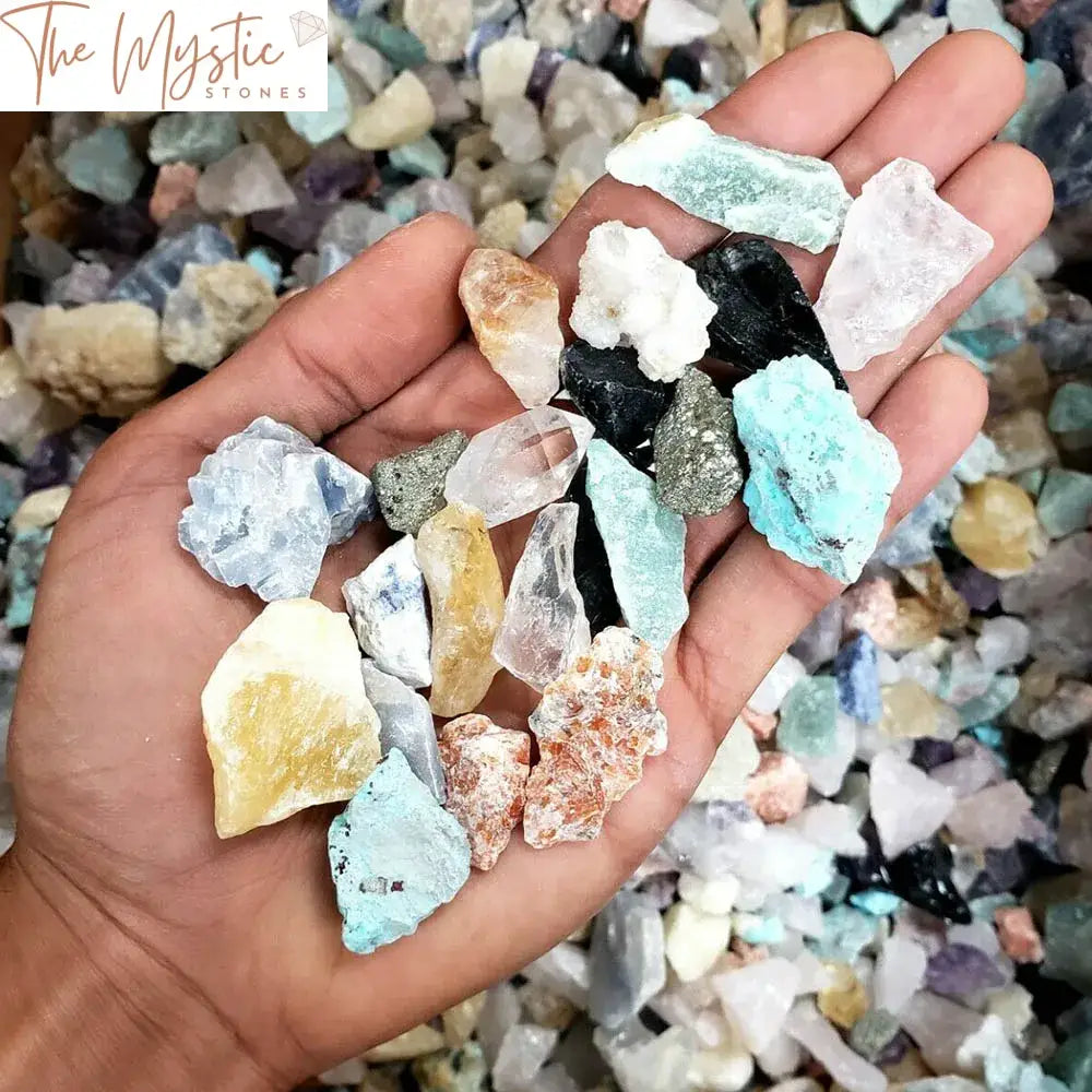 A collection of assorted natural raw crystals and small chips in various colors and shapes, displayed in a pile.