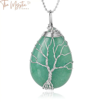 A close-up image of a Tree of Life necklace pendant featuring green aventurine stones.