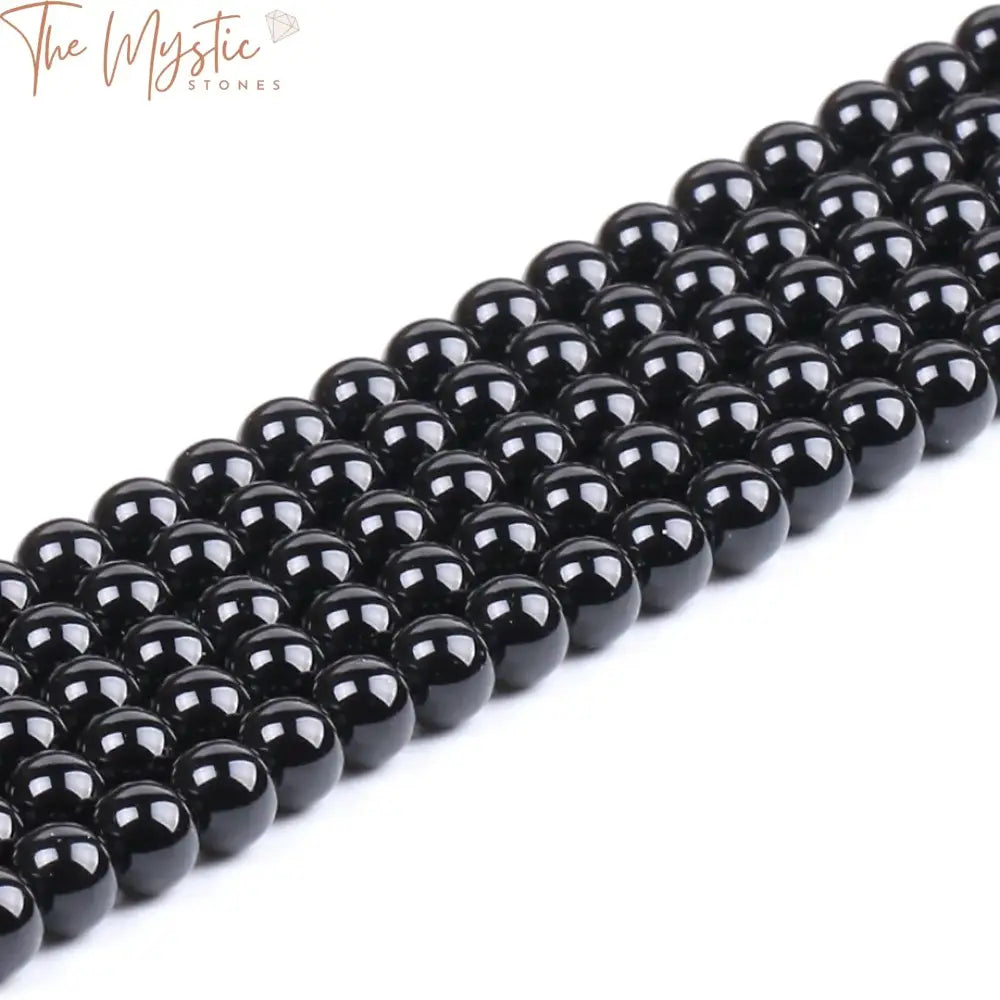 A collection of round natural stone beads in varying sizes of 4mm, 6mm, 8mm, and 10mm, made from black agate onyx.