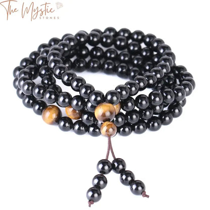 A multilayer bracelet featuring 6mm round beads of natural stones: contrasting black obsidian and tiger eye.