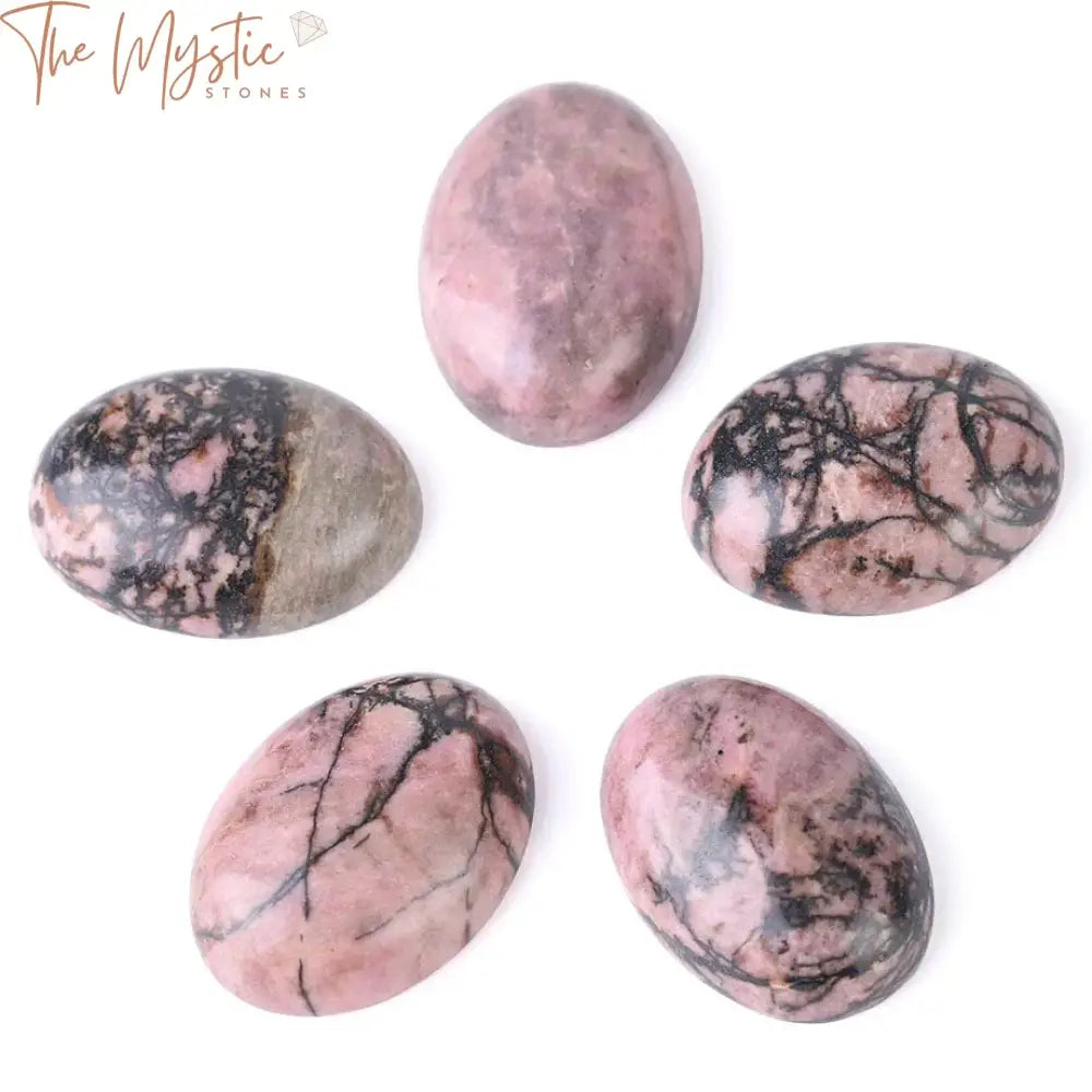 A collection of glossy black line rhodonite cabochon beads arranged on a light background.