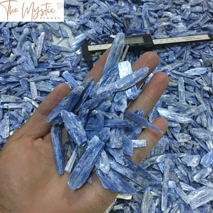 A collection of natural blue kyanite strips with varying lengths, exhibiting a vibrant blue hue and raw, uneven edges.