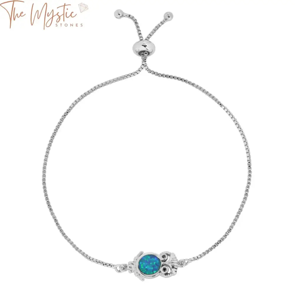 A silver-color bracelet featuring blue opal links and adorned with owl charms.