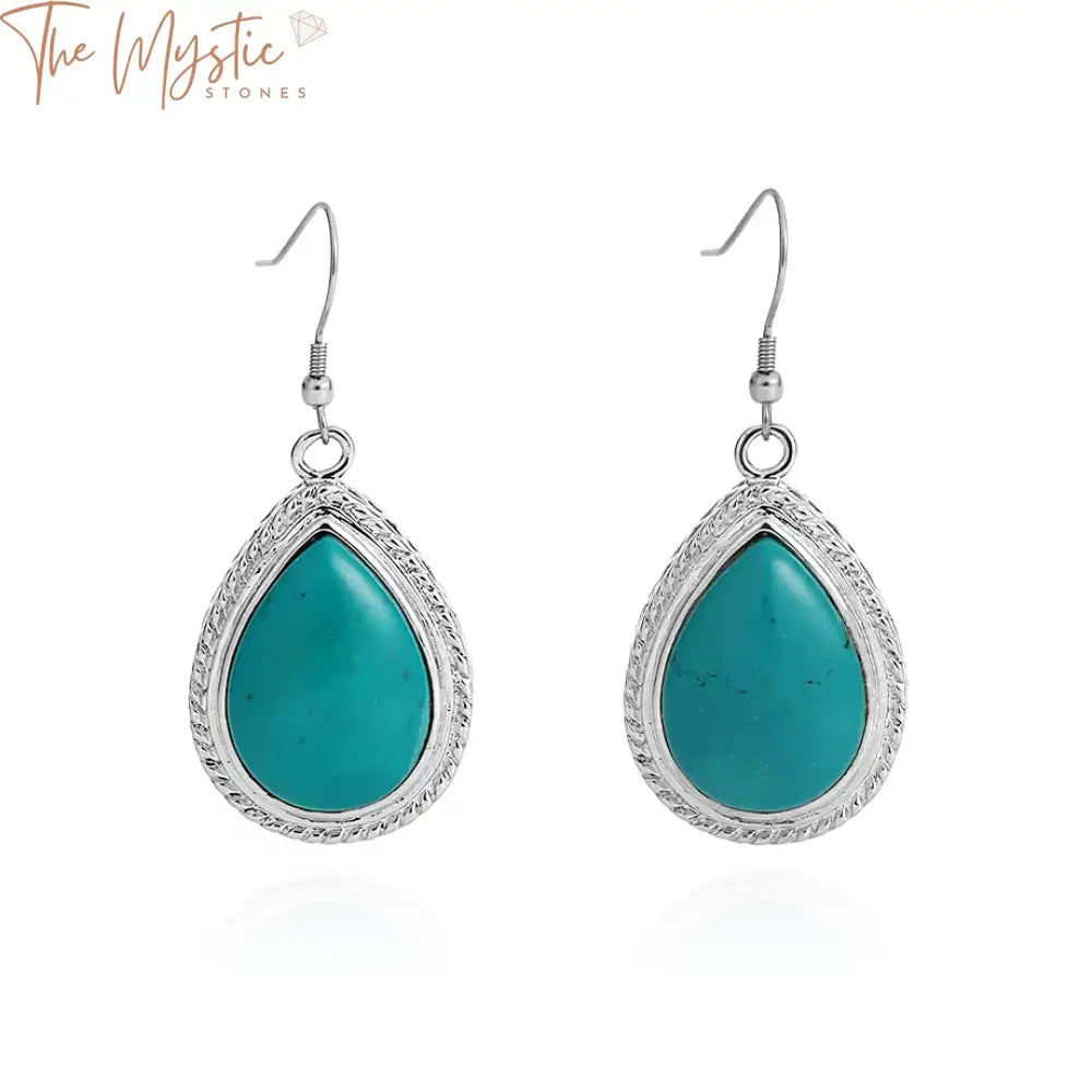 A pair of elegant blue turquoise dangle earrings with a distinctive water drop shape, designed as pendant earrings.