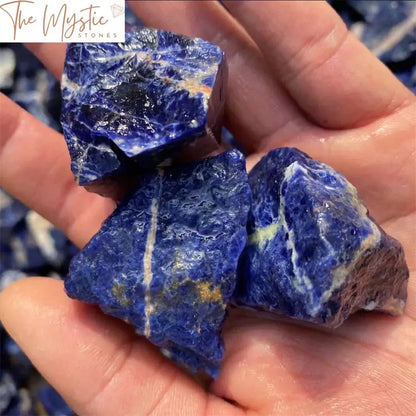 A collection of raw, crushed blue-vein stone crystals displayed on a plain surface.