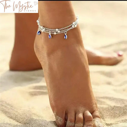 A multi-layered ankle bracelet featuring gold-colored chains adorned with various beads.