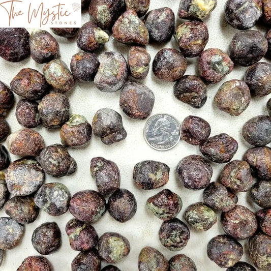 Pile of irregular, raw, rough garnet crystals in various sizes and shapes.