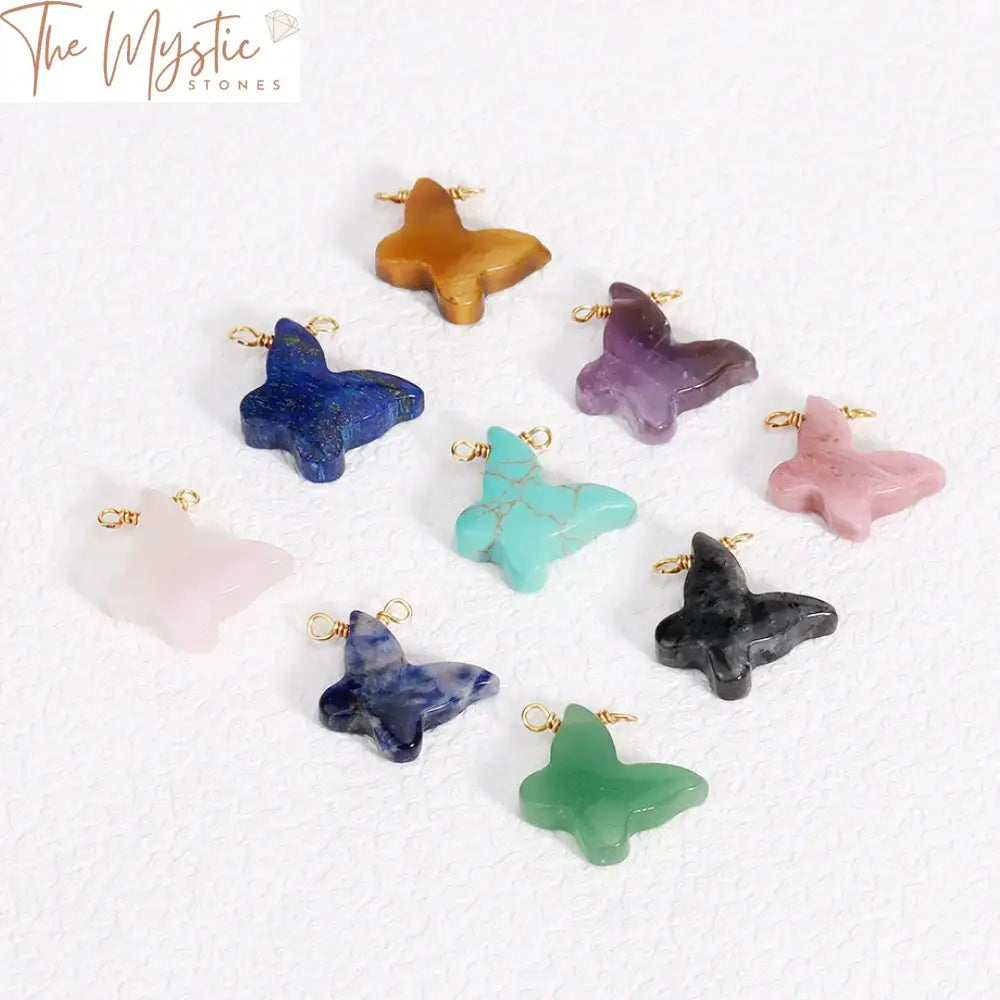 A collection of colorful, butterfly-shaped crystal charms and round natural stone beads, arranged neatly.