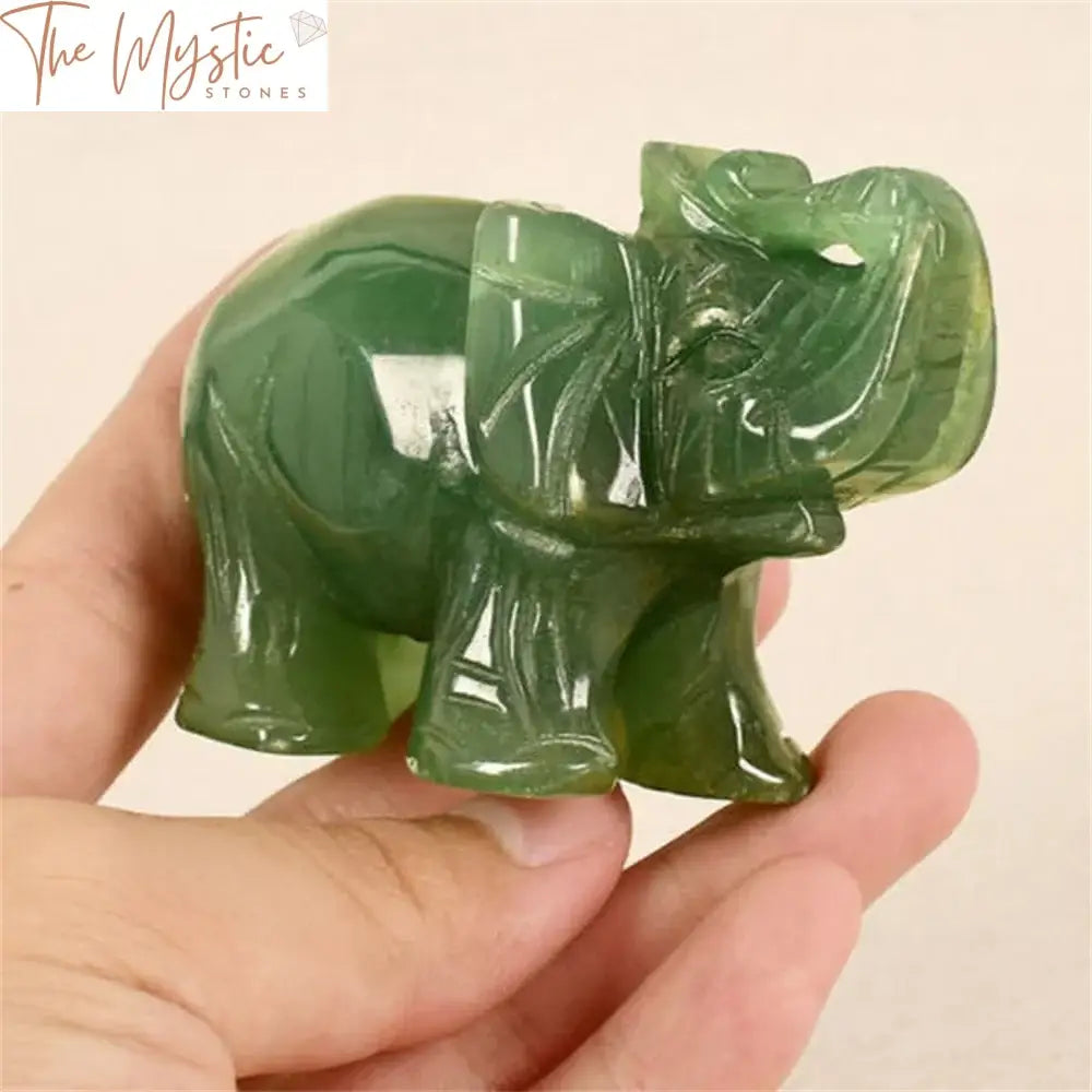 A beautifully crafted jade elephant figurine with intricate carvings, showcasing a rich green hue.