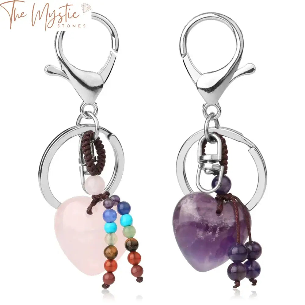 A collection of heart-shaped crystal keychains, each representing a different chakra healing stone.