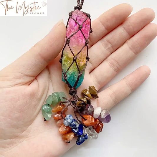 A vibrant hanging ornament featuring a column of seven raw gemstones, each representing a chakra.