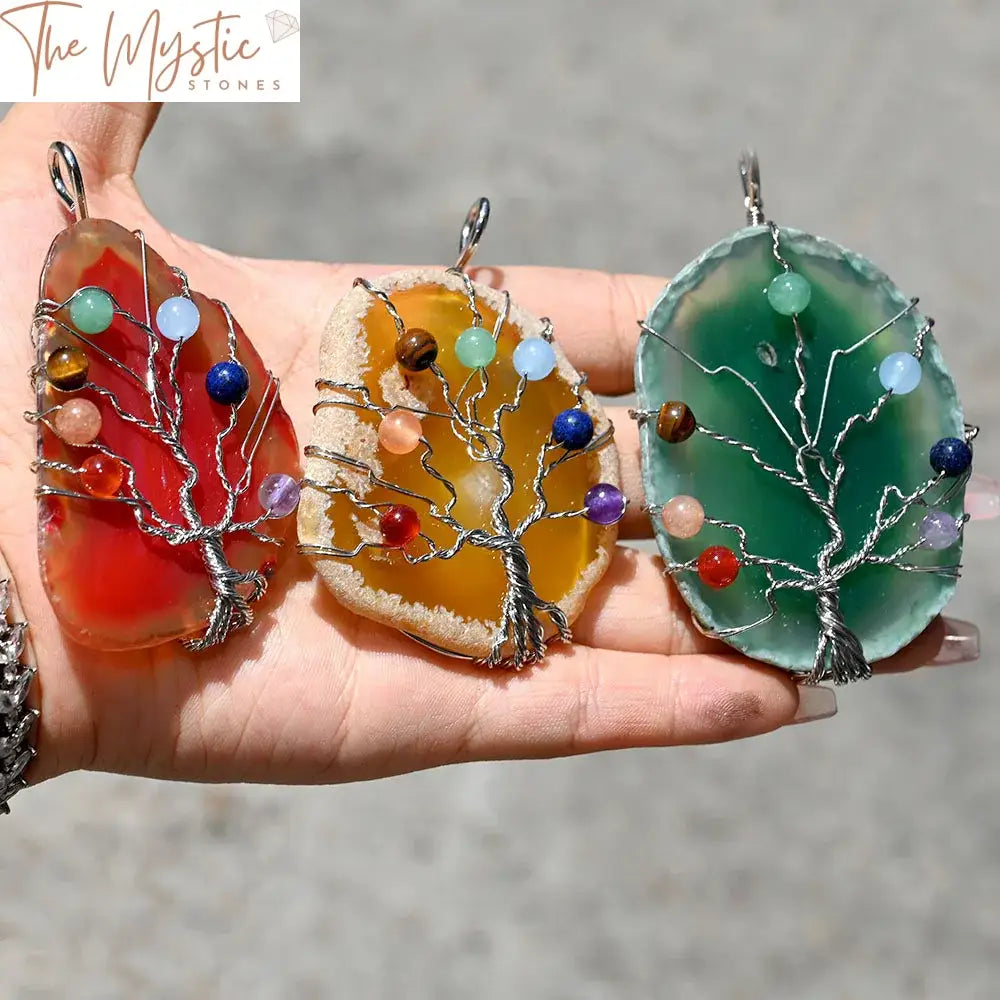 A hanging ornament with a Tree of Life design crafted from natural crystal beads representing the 7 Chakras.