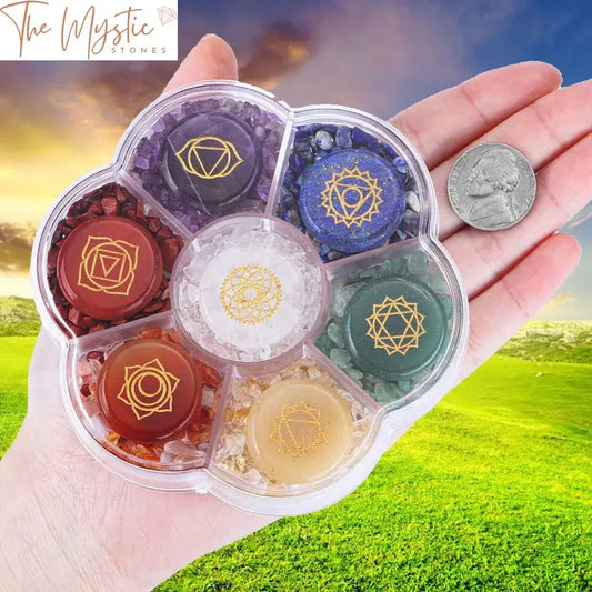 A set of seven polished crystal stones, each engraved with a unique symbol, representing the seven chakras.