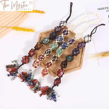 A set of seven gemstone ornaments, each representing a chakra, hang in a vertical line.