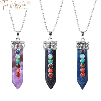 A vibrant necklace features a collection of round gemstone beads, each representing the 7 chakras with distinct colors.