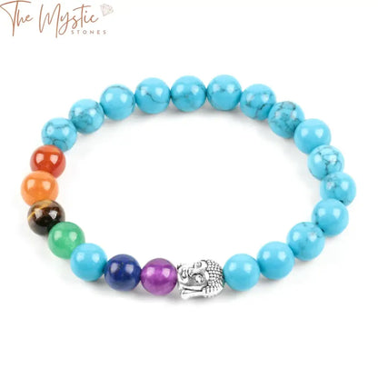 A 7 Chakra bracelet featuring 8mm blue howlite round beads interspersed with rainbow-colored chakra stones.