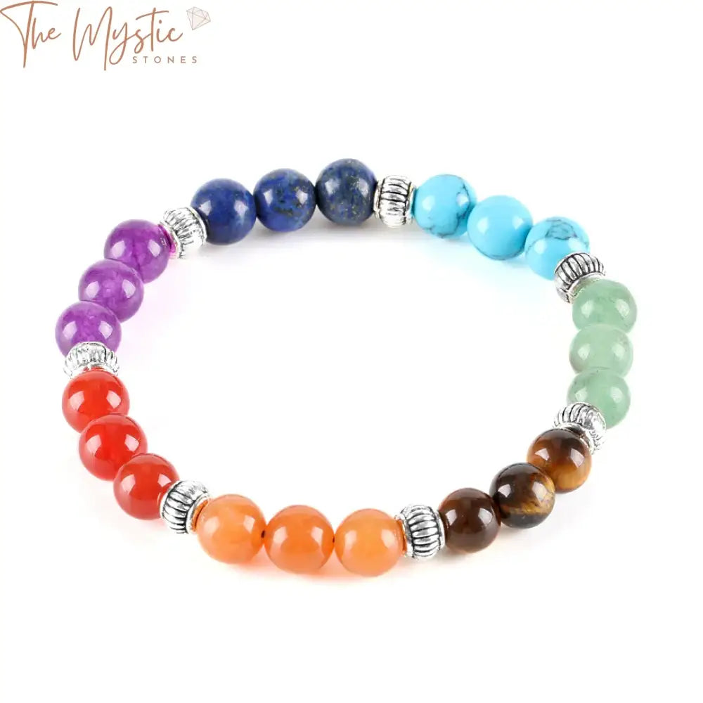 A bracelet featuring glossy, natural stone beads in the colors of the rainbow, representing the seven chakras.