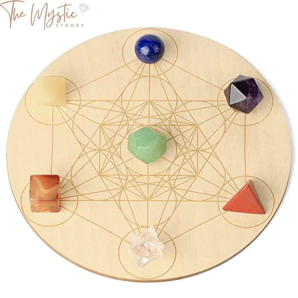 A round wooden plate displays a collection of polished, tumbled gemstones arranged in a circular formation.