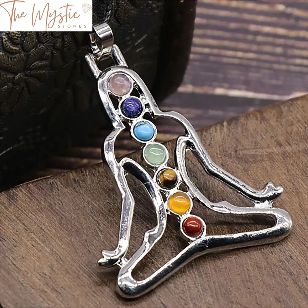 A collection of chakra yoga meditation pendants featuring assorted gemstones and charms.