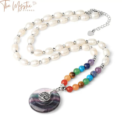 An elegant necklace featuring oval freshwater pearls interspersed with vibrant 7 chakra stones, designed as a short necklace.