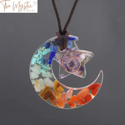 A pendant necklace featuring a star and moon design made with resin, crystal chips, and natural stones.