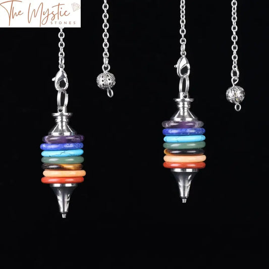 A collection of pendulums made from natural stones, each representing one of the seven chakras.