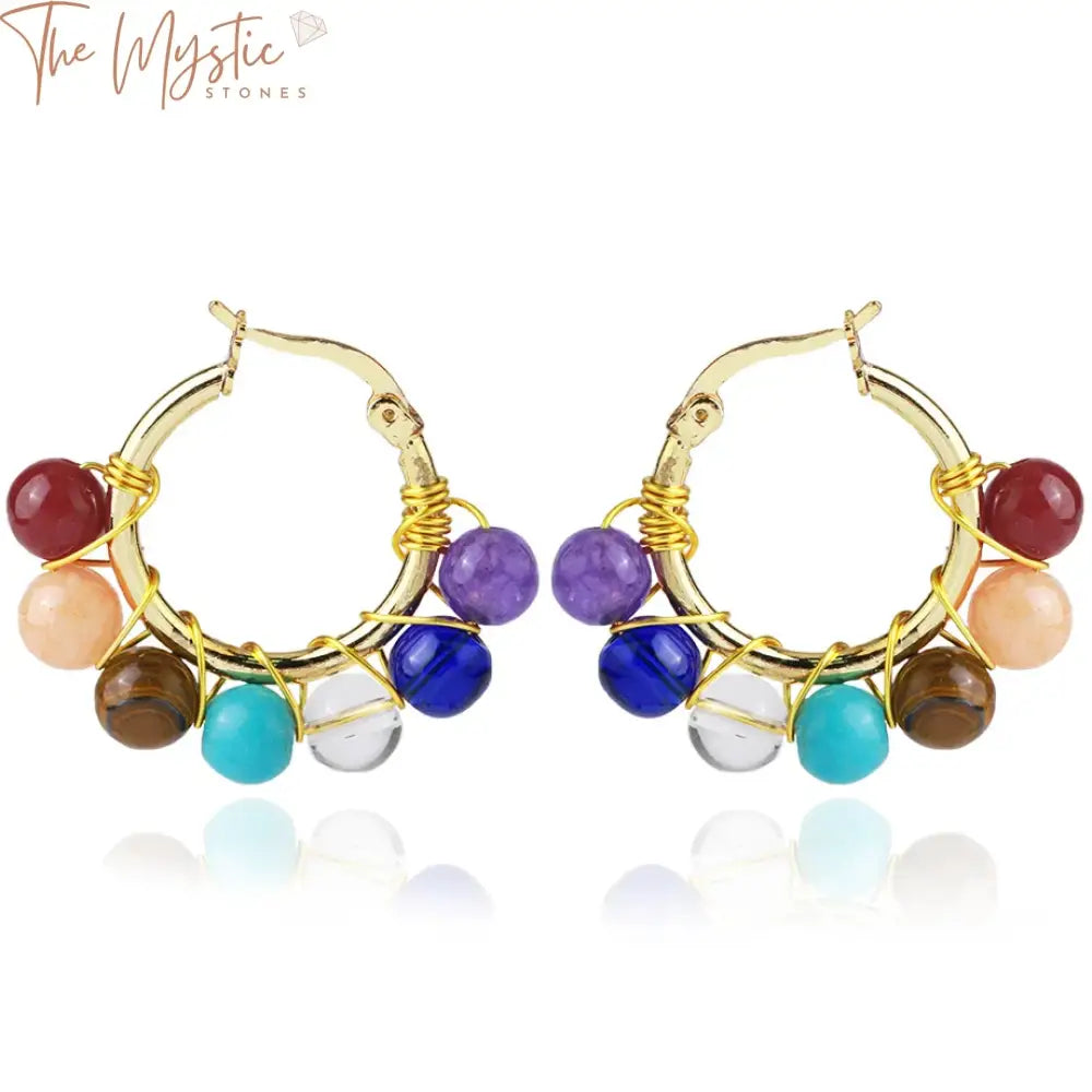 A pair of elegant earrings featuring natural stones representing the seven chakras.