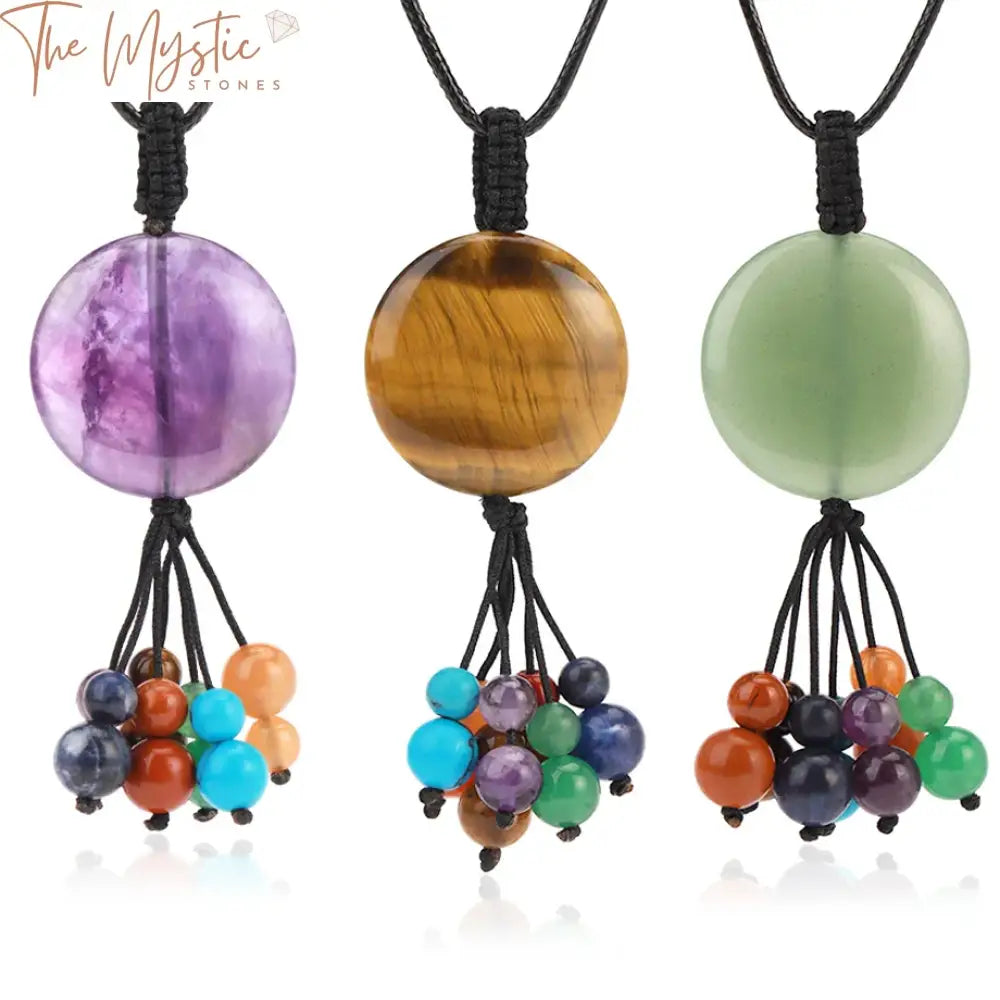 A collection of round pendant necklaces featuring natural stones, each representing the seven chakras.