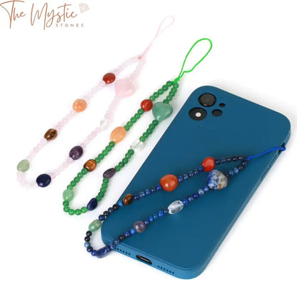 A colorful phone chain featuring seven different chakra crystals, each in a distinct color representing the chakras.