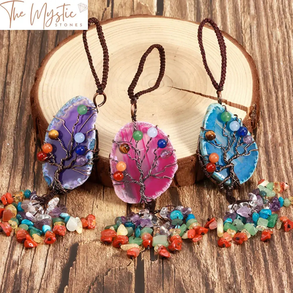 A vibrant car pendant featuring a beautifully crafted Tree of Life design, adorned with seven polished chakra gemstones.